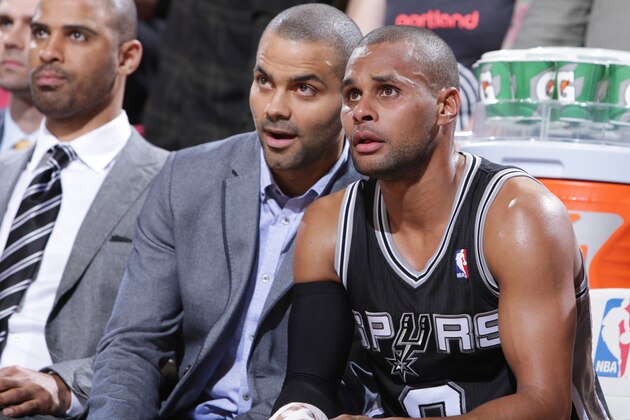 PORTLAND, OR - FEBRUARY 19:  Tony Parker #9 and Patty Mills #8 of the San Antonio Spurs talk on the bench during the game against the Portland Trail Blazers on February 19, 2014 at the Moda Center Arena in Portland, Oregon. NOTE TO USER: User expressly acknowledges and agrees that, by downloading and or using this photograph, user is consenting to the terms and conditions of the Getty Images License Agreement. Mandatory Copyright Notice: Copyright 2014 NBAE (Photo by Sam Forencich/NBAE via Getty Images)