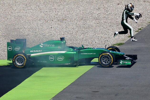 HOCKENHEIM, GERMANY - JULY 18:  Kamui Kobayashi of Japan and Caterham jumps from his car as smoke rises from the vehicle during practice ahead of the German Grand Prix at Hockenheimring on July 18, 2014 in Hockenheim, Germany.  (Photo by Mark Thompson/Getty Images)