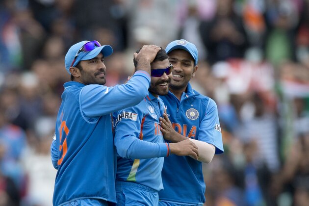India's Ravindra Jadeja, center, celebrates taking his fifth wicket of the game, that of West Indies' Ravi Rampaul, not pictured, during the ICC Champions Trophy group B cricket match between India and West Indies at The Oval cricket ground in London, Tuesday, June 11, 2013.  (AP Photo/Matt Dunham)