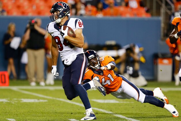 Aug 23, 2014; Denver, CO, USA; Houston Texans tight end Ryan Griffin (84) avoids the tackle of Denver Broncos defensive back Charles Mitchell (41) to run for a touchdown in the fourth quarter at Sports Authority Field at Mile High. The Texans defeated the Broncos 18-17. Mandatory Credit: Isaiah J. Downing-USA TODAY Sports