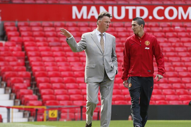 Manchester United's new player Angel Di Maria, right, and manager Louis van Gaal, pose for photographers, at Old Trafford Stadium in Manchester, England, Thursday, Aug. 28, 2014. Manchester United have signed winger Angel Di Maria from Real Madrid for a British record transfer fee of £59.7m. The Argentine winger had a medical in Manchester on Tuesday and has signed a five-year deal. (AP Photo/Alastair Grant)