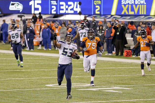 Seattle Seahawks outside linebacker Malcolm Smith (53) reacts as he returns an interception for a touchdown against the Denver Broncos during the first half of the NFL Super Bowl XLVIII football game, Sunday, Feb. 2, 2014, in East Rutherford, N.J. (AP Photo/Gregory Bull)
