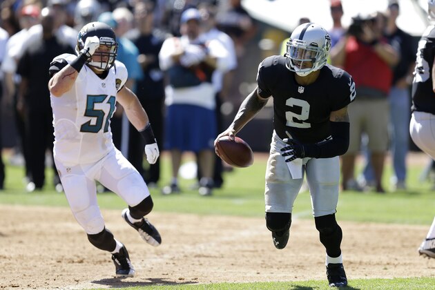 Oakland Raiders quarterback Terrelle Pryor (2) runs against Jacksonville Jaguars middle linebacker Paul Posluszny (51) during an NFL football game in Oakland, Calif., Sunday, Sept. 15, 2013. (AP Photo/Ben Margot)