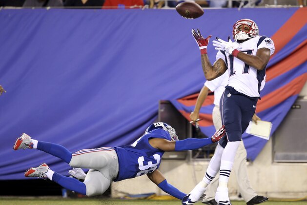 New England Patriots' Aaron Dobson, right, catches a touchdown pass while New York Giants' Trumaine McBride tries to defend during the first half of an NFL preseason football game Thursday, Aug. 28, 2014, in East Rutherford, N.J. (AP Photo/John Minchillo)