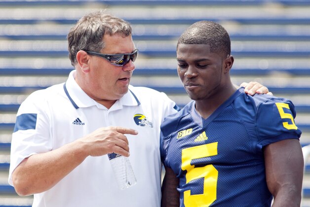 Michigan head coach Brady Hoke, left, speaks with freshman cornerback Jabrill Peppers (5) after a team photo during the NCAA college football team's preseason media day, Sunday, Aug. 10, 2014, at Michigan Stadium in Ann Arbor, Mich. (AP Photo/Tony Ding)