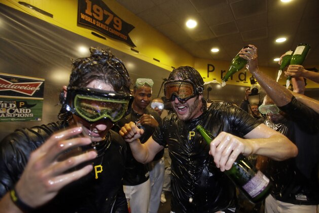 Pittsburgh Pirates Jason Grilli, center, celebrates with Jeff Locke, left, after beating the Cincinnati Reds in the National League Wild-Card playoff baseball game, 6-2, in Pittsburgh Tuesday, Oct. 1, 2013. The Pirates advance to the NLDS playoff series against the St,. Louis Cardinals. (AP Photo/Gene J. Puskar)