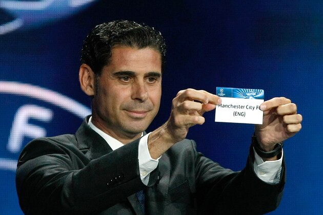Former Real madrid captain Fernando Hierro, shows the name of Manchester City, who will play Group E,  during the UEFA Champions League draw at the Grimaldi Forum, in Monaco, Thursday, Aug. 28, 2014. (AP Photo/Claude Paris)