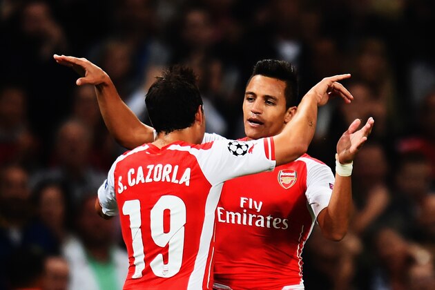 LONDON, ENGLAND - AUGUST 27:  Alexis Sanchez (R) of Arsenal celebrates with team mate Santi Cazorla of Arsenal after scoring during the UEFA Champions League Qualifier 2nd leg match between Arsenal and Besiktas at the Emirates Stadium on August 27, 2014 in London, United Kingdom.  (Photo by Shaun Botterill/Getty Images)