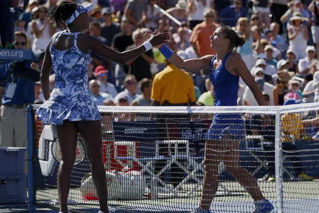 Venus Williams, of the United States, left, greets Sara Errani, of Italy, at the net after Errani won their third round match of the 2014 U.S. Open tennis tournament, Friday, Aug. 29, 2014, in New York. (AP Photo/Matt Rourke)
