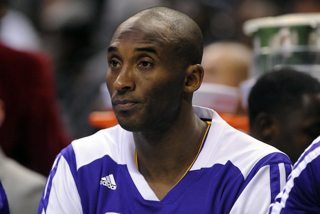 Dec 14, 2013; Charlotte, NC, USA; Los Angeles Lakers guard Kobe Bryant (24) watches his team from the bench during the first half of the game against the Los Angeles Lakers at Time Warner Cable Arena. Mandatory Credit: Sam Sharpe-USA TODAY Sports