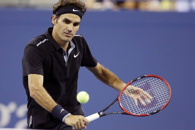Roger Federer, of Switzerland, returns a shot to Sam Groth, of Australia, during the second round of the 2014 U.S. Open tennis tournament Friday, Aug. 29, 2014, in New York. (AP Photo/Darron Cummings)