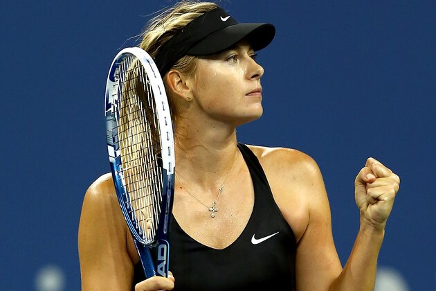 NEW YORK, NY - AUGUST 29:  Maria Sharapova of Russia celebrates match point against Sabine Lisicki of Germany in the second set during their women's singles second round match on Day Five of the 2014 US Open at the USTA Billie Jean King National Tennis Center on August 29, 2014 in the Flushing neighborhood of the Queens borough of New York City.  (Photo by Elsa/Getty Images)