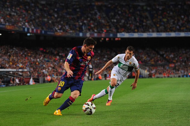 BARCELONA, SPAIN - AUGUST 24:  Lionel Messi of FC Barcelona takes on Edu Albacar of Elche FC during the La Liga match between FC Barcelona and Elche FC at Camp Nou stadium on August 24, 2014 in Barcelona, Spain.  (Photo by Denis Doyle/Getty Images)