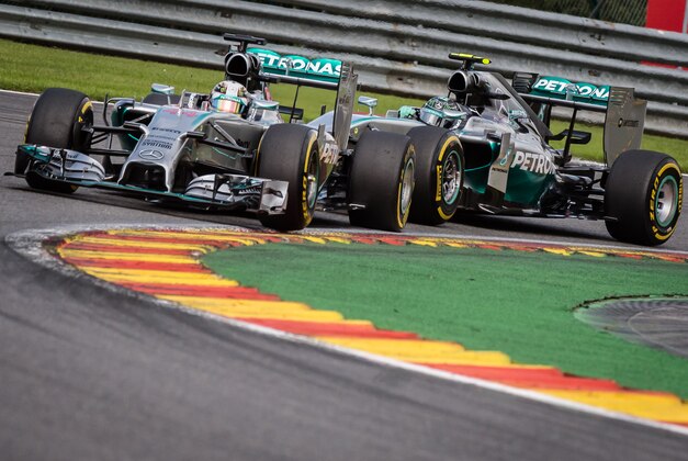 Mercedes drivers Lewis Hamilton of Britain, left, and Nico Rosberg of Germany steer their cars during the Belgian Formula One Grand Prix in Spa-Francorchamps, Belgium, Sunday, Aug. 24, 2014. Red Bull driver Daniel Ricciardo of Australia won the race, Mercedes driver Nico Rosberg of Germany finished second and Williams driver Valtteri Bottas of Finland third. (AP Photo/Geert Vanden Wijngaert)
