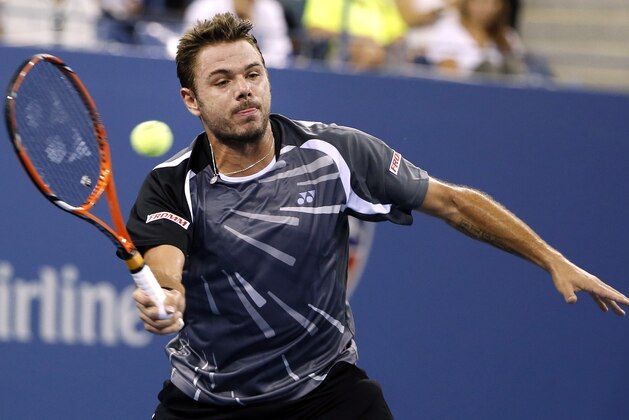 Stan Wawrinka, of Switzerland, returns a shot to Thomaz Bellucci, of Brazil, during the second round of the U.S. Open tennis tournament Wednesday, Aug. 27, 2014, in New York. (AP Photo/Jason DeCrow)