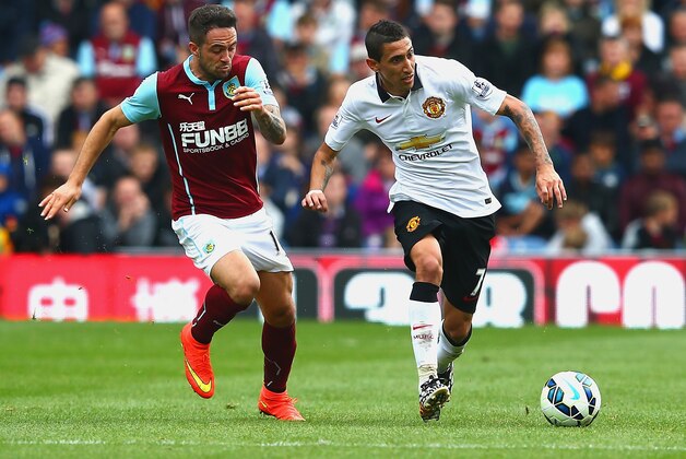 BURNLEY, ENGLAND - AUGUST 30:  Danny Ings of Burnley and Angel di Maria of Manchester United compete for the ball during the Barclays Premier League match between Burnley and Manchester United at Turf Moor on August 30, 2014 in Burnley, England.  (Photo by Mark Thompson/Getty Images)