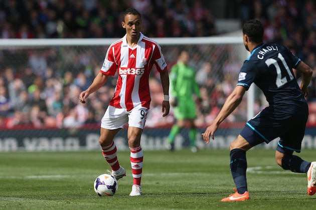 STOKE ON TRENT, ENGLAND - APRIL 26:  Peter Odemwingie of Stoke City in action with Nacer Chadli of Tottenham Hotspur during the Barclays Premier League match between Stoke City and Tottenham Hotspur at the Britannia Stadium on April 26, 2014 in Stoke on Trent, England.  (Photo by Clive Brunskill/Getty Images)