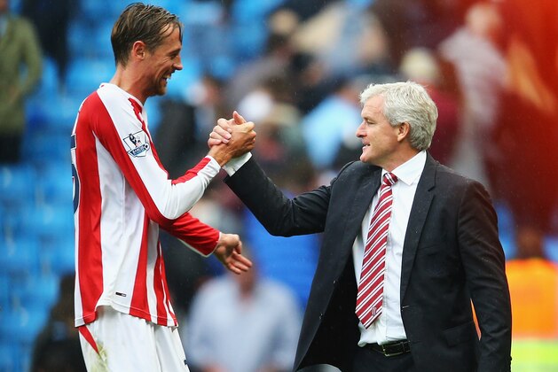MANCHESTER, ENGLAND - AUGUST 30:  Peter Crouch of Stoke City celebrates victory with Mark Hughes, manager of Stoke City after the Barclays Premier League match between Manchester City and Stoke City at Etihad Stadium on August 30, 2014 in Manchester, England.  (Photo by Clive Mason/Getty Images)