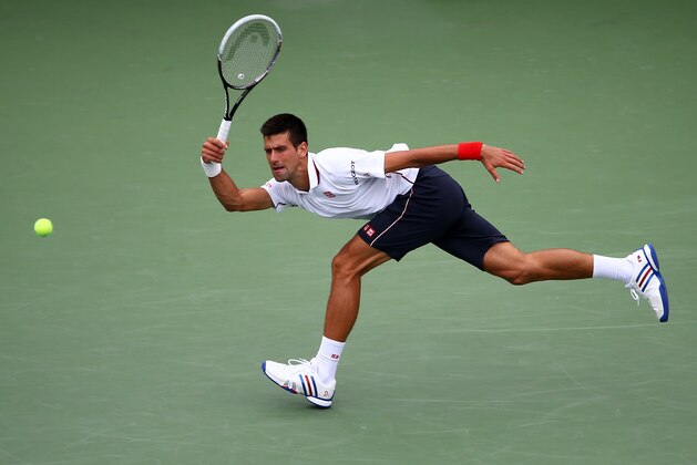 NEW YORK, NY - AUGUST 30:  Novak Djokovic of Serbia returns a shot against Sam Querrey of the United States during their men's singles third round match on Day Six of the 2014 US Open at the USTA Billie Jean King National Tennis Center on August 30, 2014 in the Flushing neighborhood of the Queens borough of New York City.  (Photo by Streeter Lecka/Getty Images)