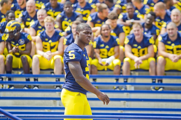 Michigan freshman cornerback Jabrill Peppers (5) walks with teammates to a team photo during the NCAA college football team's preseason media day, Sunday, Aug. 10, 2014, at Michigan Stadium in Ann Arbor, Mich. (AP Photo/Tony Ding)
