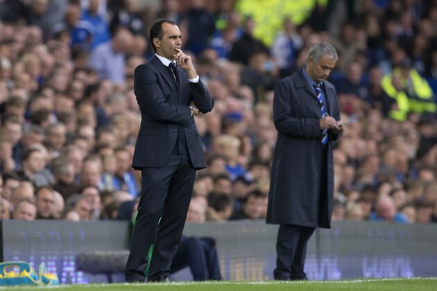 Everton's manager Roberto Martinez, left, stands alongside Chelsea's manager Jose Mourinho during their English Premier League soccer match at Goodison Park Stadium, Liverpool, England, Saturday Aug. 30, 2014. (AP Photo/Jon Super)