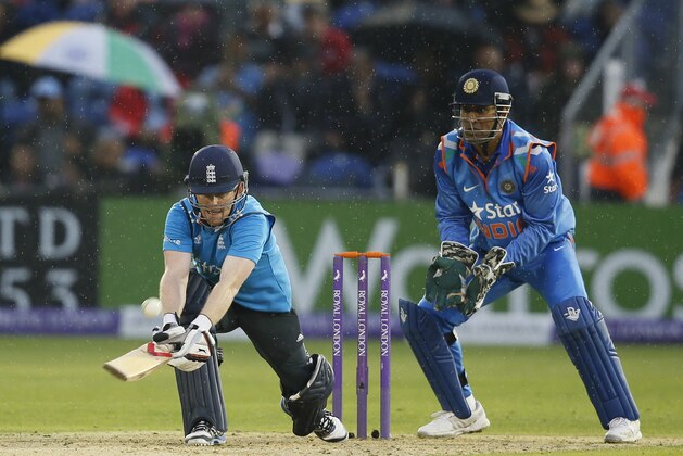 England's Eoin Morgan hits a ball bowled by India's Ravindra Jadeja during their One Day International cricket match at the SWALEC cricket ground in Cardiff, Wales, Wednesday, Aug. 27, 2014. (AP Photo / Alastair Grant)
