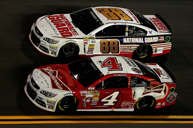 DAYTONA BEACH, FL - FEBRUARY 20: Kevin Harvick, driver of the #4 Budweiser Chevrolet, and Dale Earnhardt Jr., driver of the #88 National Guard Chevrolet, race during the NASCAR Sprint Cup Series Budweiser Duel 1 at Daytona International Speedway on February 20, 2014 in Daytona Beach, Florida.  (Photo by Sean Gardner/Getty Images)
