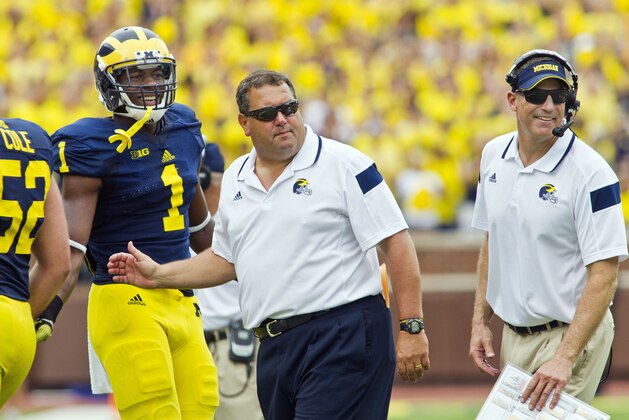 Michigan wide receiver Devin Funchess (1) stands with head coach Brady Hoke, center, and offensive coordinator Doug Nussmeier, right, greeting players coming off the field after a touchdown in the third quarter of an NCAA college football game against Appalachian State in Ann Arbor, Mich., Saturday, Aug. 30, 2014. Michigan won 52-14. (AP Photo/Tony Ding)