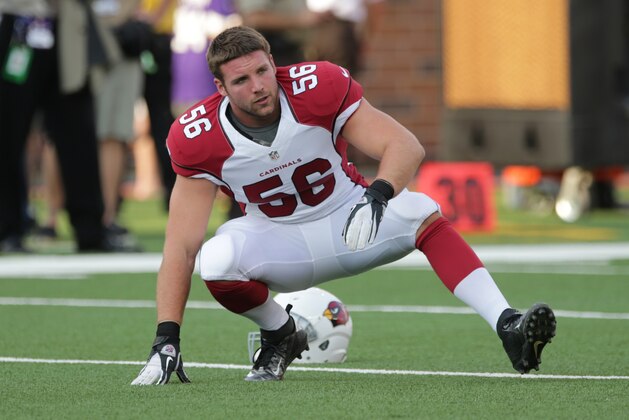 Arizona Cardinals linebacker Glenn Carson stretches before an NFL preseason football game against the Minnesota Vikings, Saturday, Aug. 16, 2014, in Minneapolis. (AP Photo/Jim Mone)