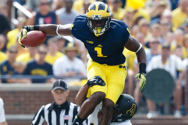 Aug 30, 2014; Ann Arbor, MI, USA; Michigan Wolverines wide receiver Devin Funchess (87) leaps over Appalachian State Mountaineers defensive back Dante Blackmon (24) as linebacker Rashaad Townes (31) grabs him from behind in the first quarter at Michigan Stadium. Mandatory Credit: Rick Osentoski-USA TODAY Sports Aug 30, 2014; Ann Arbor, MI, USA; Michigan Wolverines wide receiver Devin Funchess (87) leaps over Appalachian State Mountaineers defensive back Dante Blackmon (24) as linebacker Rashaad Townes (31) grabs him from behind in the first quarter at Michigan Stadium. Mandatory Credit: Rick Osentoski-USA TODAY Sports