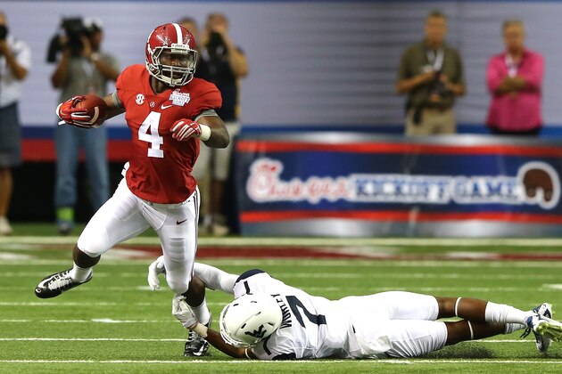 ATLANTA, GA - AUGUST 30:  T.J. Yeldon #4 of the Alabama Crimson Tide breaks a tackle by Daryl Worley #7 of the West Virginia Mountaineers at Georgia Dome on August 30, 2014 in Atlanta, Georgia.  (Photo by Martin Rose/Getty Images)