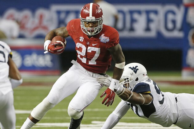 Alabama running back Derrick Henry (27) tries to escape  from West Virginia defensive lineman Noble Nwachukwu (97) in the second half of an NCAA college football game Saturday, Aug. 30, 2014, in Atlanta. (AP Photo/John Bazemore)