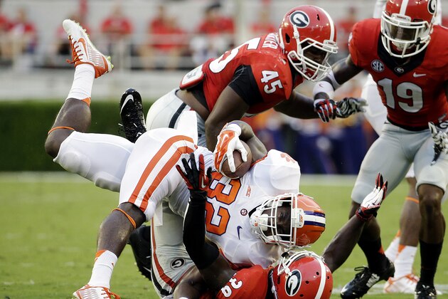Clemson's C.J. Davidson (32) is tackled by Georgia's Corey Moore, bottom, in the first half of an NCAA college football game, Saturday, Aug. 30, 2014, in Athens, Ga. Georgia won 45-21. (AP Photo/David Goldman)