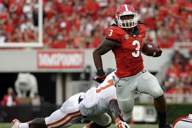 Georgia's Todd Gurley, right, runs past the reach of Clemson's Tony Steward in the first half of an NCAA college football game, Saturday, Aug. 30, 2014, in Athens, Ga. Georgia won 45-21. (AP Photo/David Goldman)