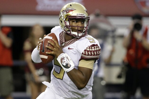 Florida State quarterback Jameis Winston rolls out of the pocket in the first half of an NCAA college football game against Oklahoma State, Saturday, Aug. 30, 2014, in Arlington, Texas. (AP Photo/Tony Gutierrez)