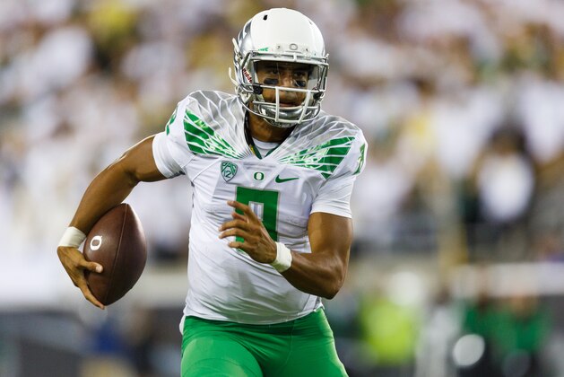 Oregon quarterback Marcus Mariota runs the football during the second quarter of an NCAA college football game against South Dakota in Eugene, Ore., Saturday, Aug. 30, 2014. (AP Photo/Ryan Kang)