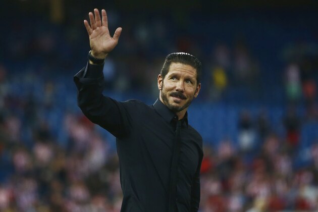 Atletico's coach Diego Simeone from Argentina, salutes the fans during a Spanish La Liga soccer match between Atletico de Madrid and Eibar at the Vicente Calderon stadium in Madrid, Spain, Saturday, Aug. 30, 2014. (AP Photo/Andres Kudacki)