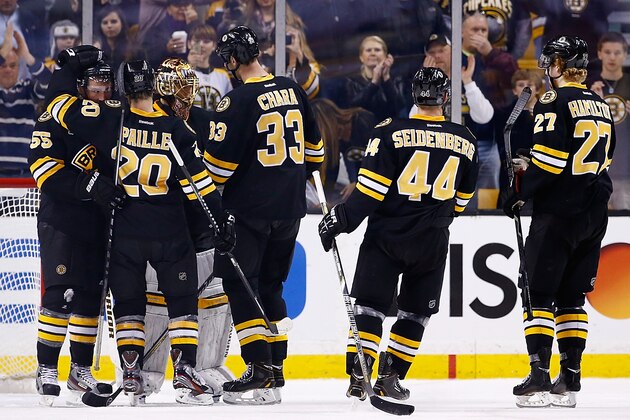 BOSTON, MA - NOVEMBER 29: Tuukka Rask #40 of the Boston Bruins celebrates with teammates following their 3-2 win against the New York Rangers during the game at TD Garden on November 29, 2013 in Boston, Massachusetts.  (Photo by Jared Wickerham/Getty Images)