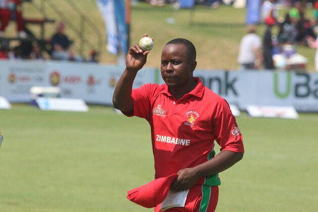 Zimbabwean bowler Prosper Utseya walks off the pitch while holding the ball after getting a hat trick during the cricket One Day International match against South Africa in Harare, Zimbabwe, Friday, Aug. 29, 2014.(AP Photo/Tsvangirayi Mukwazhi)