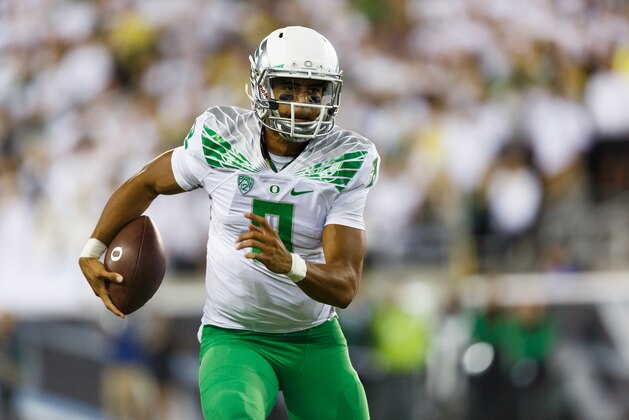 Oregon quarterback Marcus Mariota runs the football during the second quarter of an NCAA college football game against South Dakota in Eugene, Ore., Saturday, Aug. 30, 2014. (AP Photo/Ryan Kang)