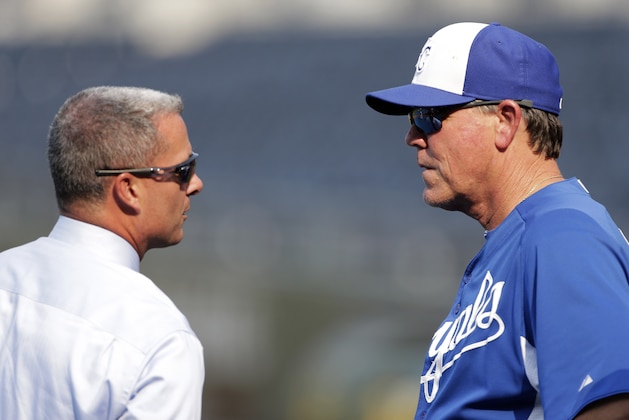 Kansas City Royals manager Ned Yost talks with general manager Dayton Moore before a baseball game against the Chicago White Sox Wednesday, Aug. 21, 2013, in Kansas City, Mo. (AP Photo/Charlie Riedel)
