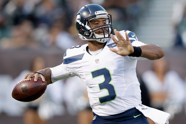 OAKLAND, CA - AUGUST 28: Quarterback Russell Wilson #3 of the Seattle Seahawks passes the ball against the Oakland Raiders during a preseason game at O.co Coliseum on August 28, 2014 in Oakland, California.  (Photo by Ezra Shaw/Getty Images)