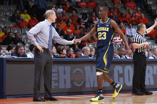 CHAMPAIGN, IL - MARCH 4: Head coach John Beilein of the Michigan Wolverines congratulates Caris LeVert #23 during the game against the Illinois Fighting Illini at State Farm Center on March 4, 2014 in Champaign, Illinois. Michigan defeated Illinois 84-53. (Photo by Joe Robbins/Getty Images)