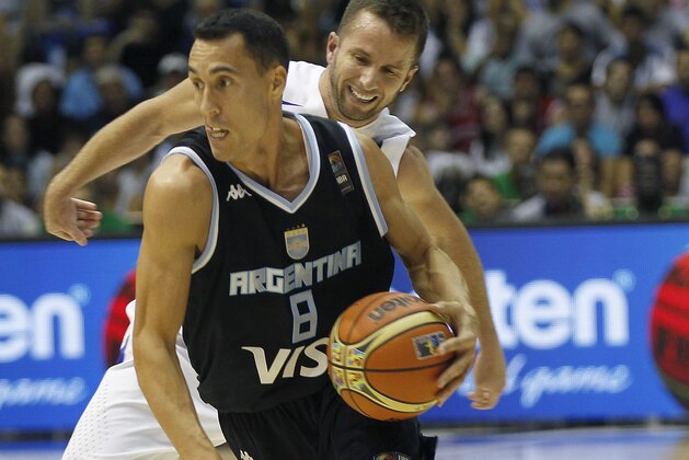 Argentina's Pablo Priogini, front, vies with Puerto Rico's Jose Barea, behind, during the Group B Basketball World Cup match between Argentina and Puerto Rico in Seville, Spain, Saturday, Aug. 30, 2014. The 2014 Basketball World Cup competition will take place in various cities in Spain from Aug. 30 through to Sept. 14. (AP Photo/Miguel Angel Morenatti)