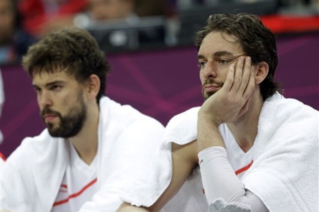 Spain's Marc Gasol, left, and brother Spain's Pau Gasol, right, sit on the bench during a preliminary men's basketball game against Brazil at the 2012 Summer Olympics, Monday, Aug. 6, 2012, in London. (AP Photo/Eric Gay)