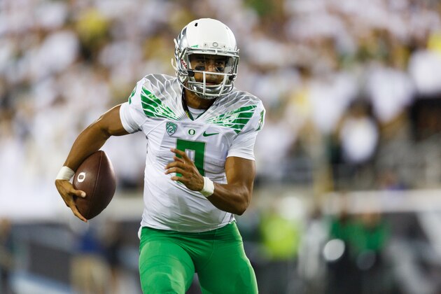 Oregon quarterback Marcus Mariota runs the football during the second quarter of an NCAA college football game against South Dakota in Eugene, Ore., Saturday, Aug. 30, 2014. (AP Photo/Ryan Kang)