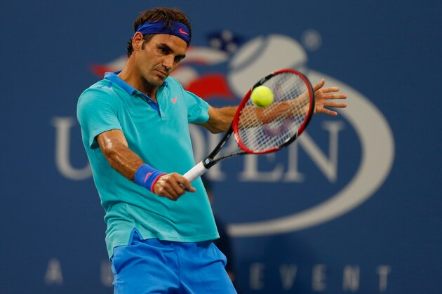 NEW YORK, NY - AUGUST 31: Roger Federer of Switzerland returns a shot to Marcel Granollers of Spain during their men's singles third round match on Day Seven of the 2014 US Open at the USTA Billie Jean King National Tennis Center on August 31, 2014 in the Flushing neighborhood of the Queens borough of New York City.  (Photo by Mike Stobe/Getty Images for USTA)