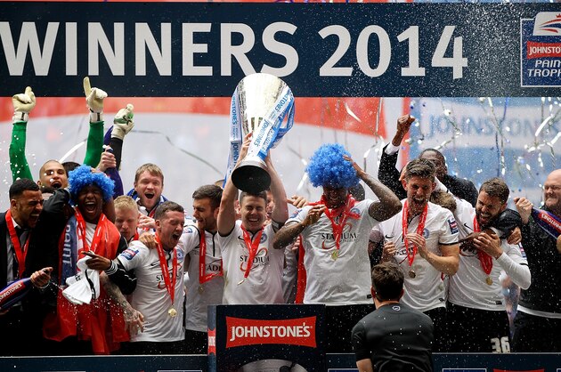 LONDON, ENGLAND - MARCH 30: Peterborough captain Tommy Rowe lifts the trophy after his team won the Johnstone's Paint Trophy Final between Chesterfield and Peterborough United at Wembley Stadium on March 30, 2014 in London, England. (Photo by Ben Hoskins/Getty Images) LONDON, ENGLAND - MARCH 30: Peterborough captain Tommy Rowe lifts the trophy after his team won the Johnstone's Paint Trophy Final between Chesterfield and Peterborough United at Wembley Stadium on March 30, 2014 in London, England. (Photo by Ben Hoskins/Getty Images)