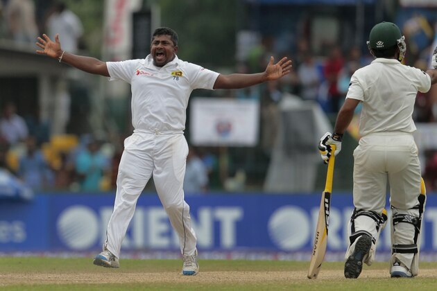 Sri Lanka's Rangana Herath, left, successfully appeals for the wicket of Pakistani batsman Younis Khan as non striker Asad Shafiq watches during the fourth day of their second test cricket match  in Colombo, Sri Lanka, Sunday, Aug. 17, 2014. (AP Photo/Eranga Jayawardena)