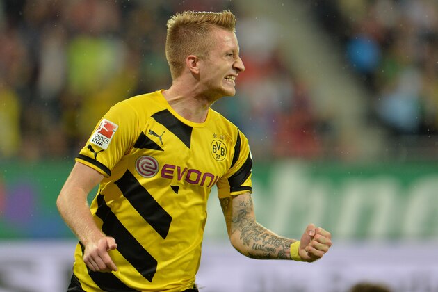 Dortmund's Marco Reus celebrates after scoring during the  soccer match between FC Augsburg and Borussia Dortmund in the SLG Arena in Augsburg, Germany, on Friday, Aug. 29, 2014. (AP Photo/Kerstin Joensson)